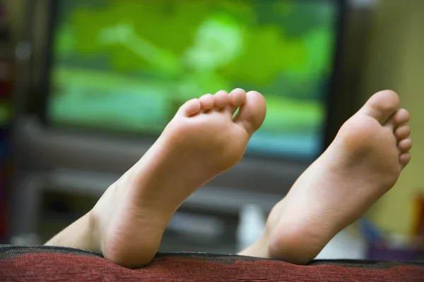 Child Lying On Sofa With Feet In Air — Stock Photo, Image