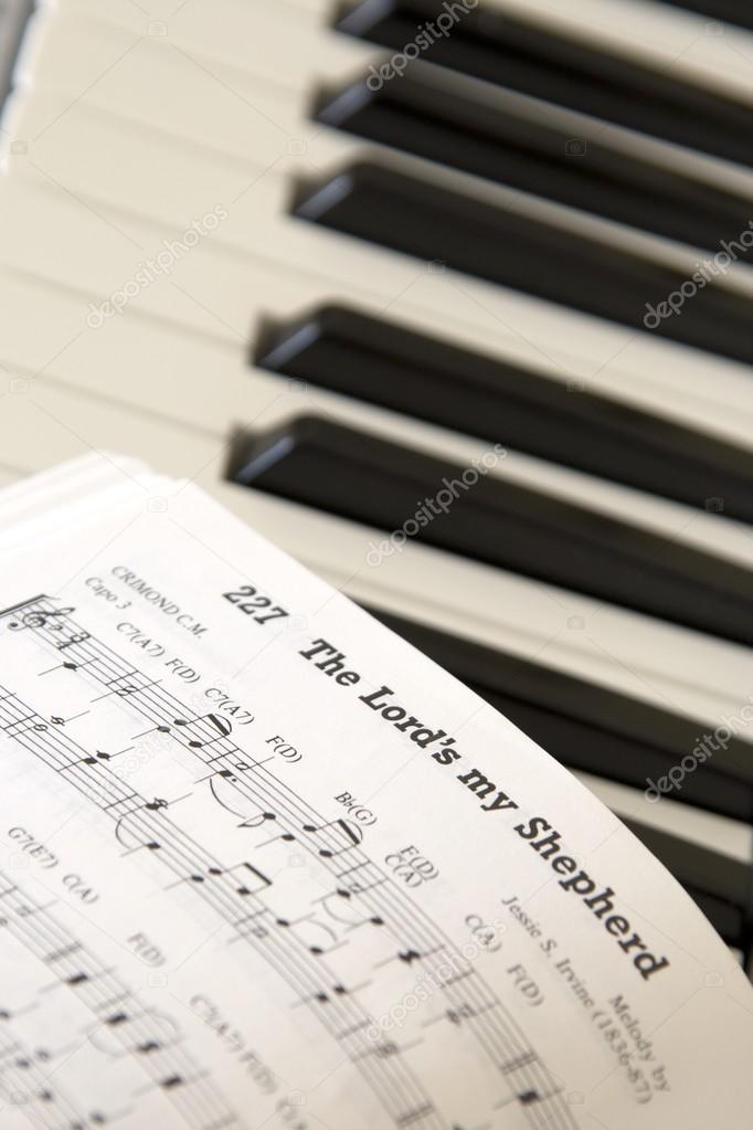 Close Up Of Sheet Music On Piano Keyboard