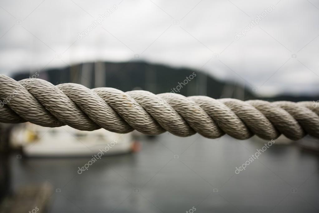 Close Up Thick Rope, With Fishing Boats In Background