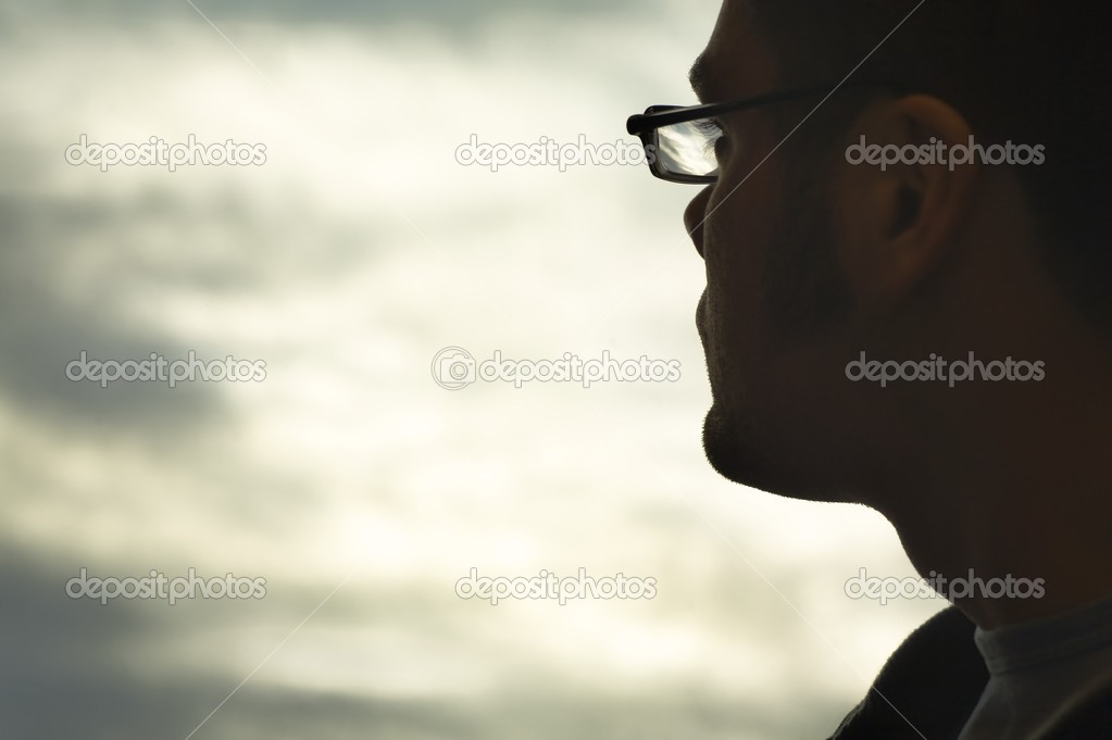 A Man Looking Into The Clouds