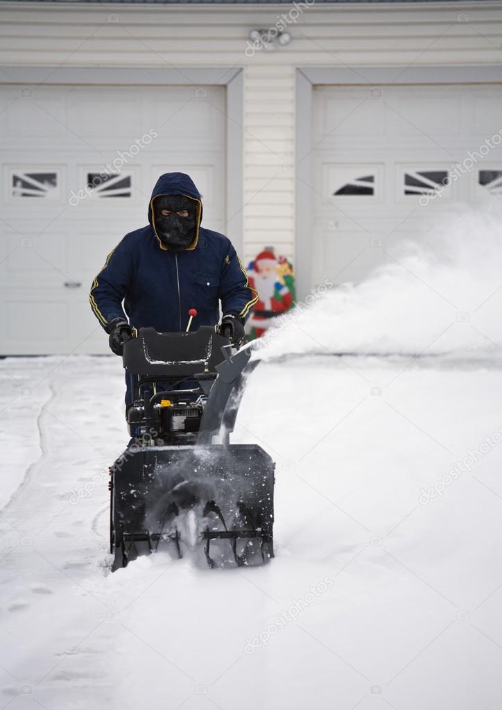 Man Operating A Snow Blower