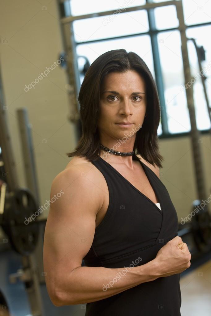 Woman Flexing Her Arm Muscles Stock Photo by ©DesignPicsInc 31799309