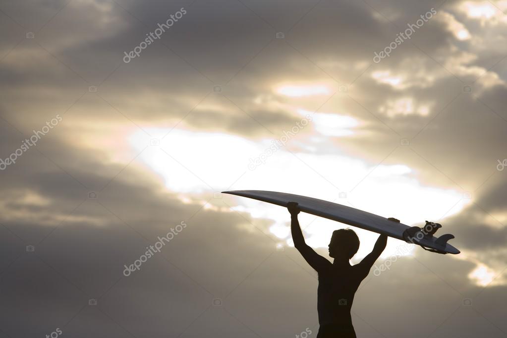 A Surfer On Muriwai Beach, New Zealand