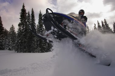 Man Jumping A Snowmobile clipart