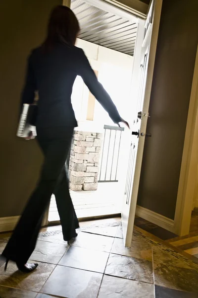 Woman Walking Out A Door — Stock Photo, Image