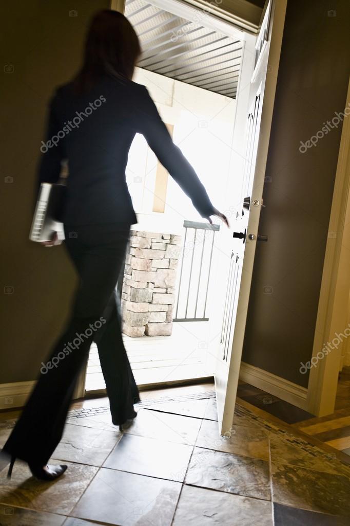 Woman Walking Out A Door