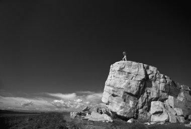 Hiker On Top Of Large Boulder clipart