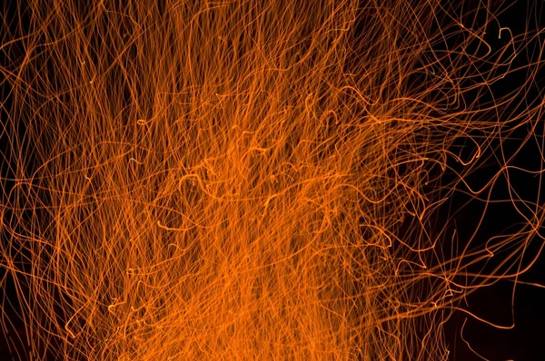 Oheň jiskry proti temnotě noci — Stock fotografie