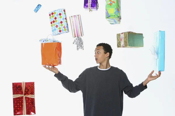 Man Juggling Holiday Gifts — Stock Photo, Image