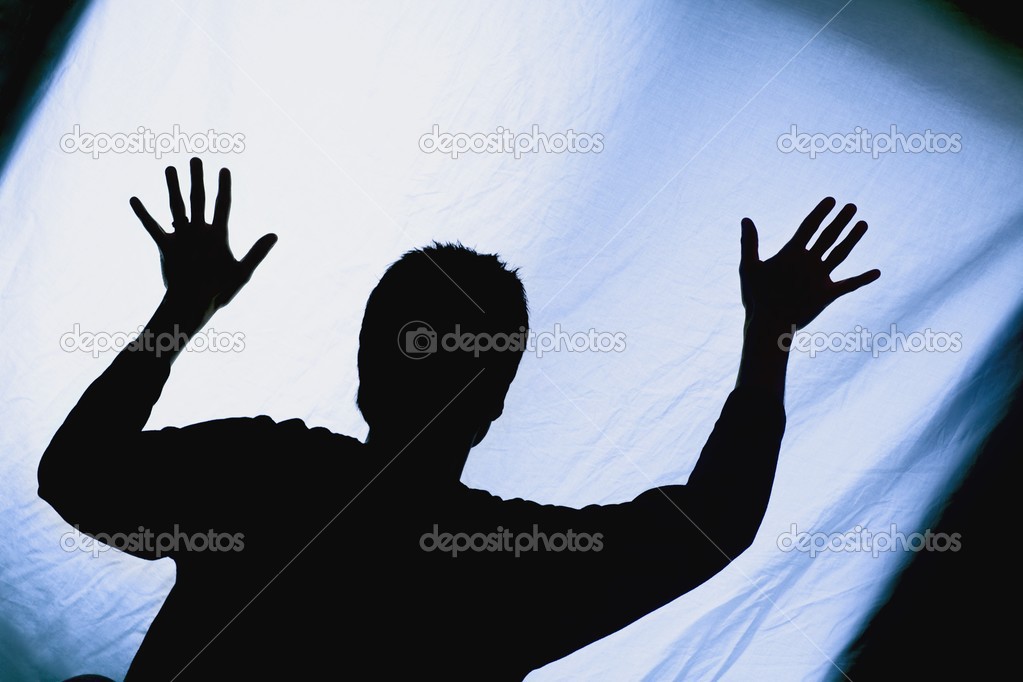 Silhouette Of A Man With Arms Raised