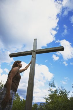 Woman Touches The Cross clipart