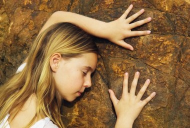 Child Touching A Rock clipart