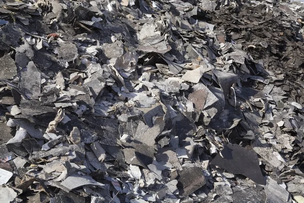Pile Of Discarded Asphalt Roofing Shingles In A Recycling Yard