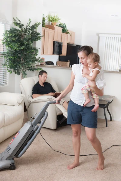 Mother Trying To Vacuum While The Father Sits Around — Stock Photo, Image