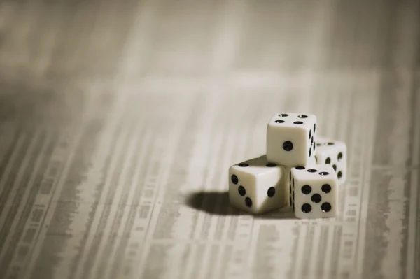 Two dices isolated on newspaper — Stock Photo, Image