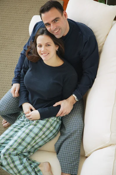 Couple Snuggles On Sofa — Stock Photo, Image