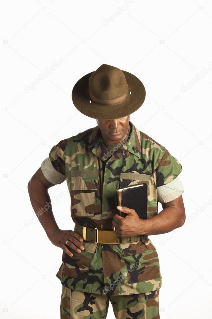 Military Man Holding A Bible