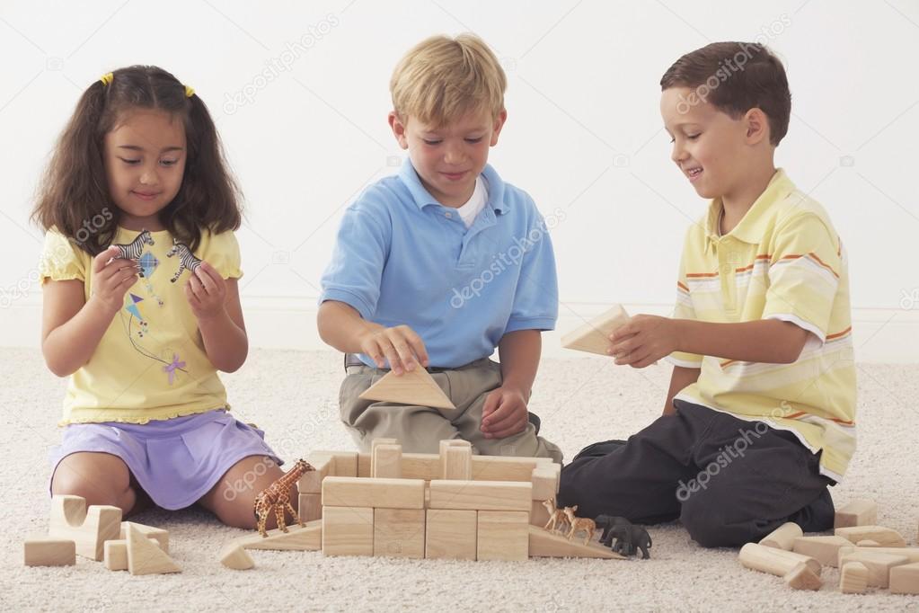 Three Children Building Noah's Ark With Wooden Blocks