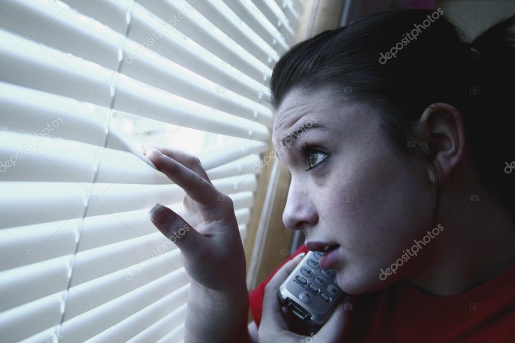 Teenage Girl On The Phone, Peeking Out A Window