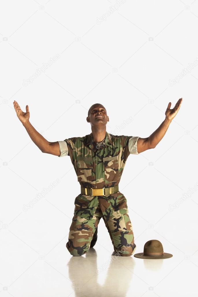 Military Man With Arms In The Air And Looking Upwards
