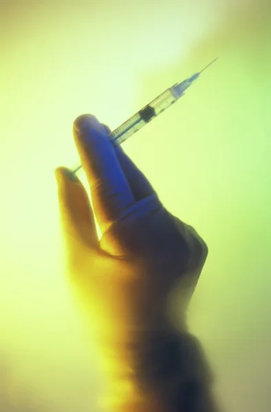 Syringe in hand — Stock Photo, Image