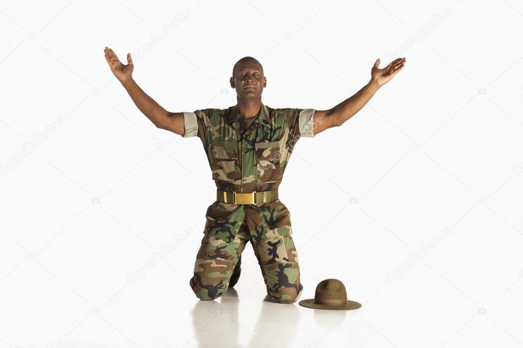 Military Man With Arms Raised And Eyes Closed