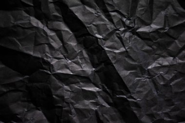 Buruşmuş siyah kağıt arkaplanı.