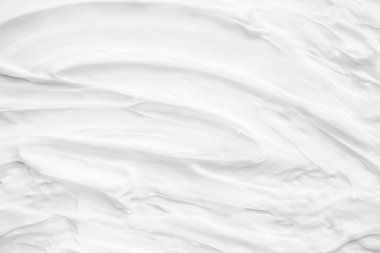 Krem losyonun beyaz yüzeyi arka planı yumuşatır..