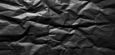 Soyut siyah buruşmuş kağıt doku arkaplanı.