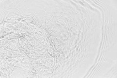 Waves on transparent water surface, gray abstract background.