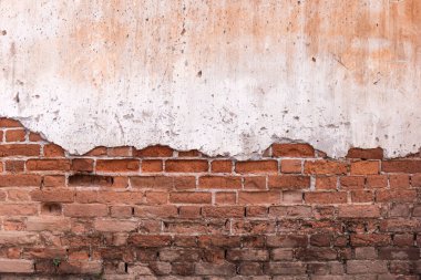 Old broken wall background with bricks.