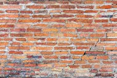 Old broken wall background with bricks.