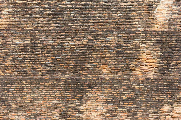 Old broken wall background with bricks.