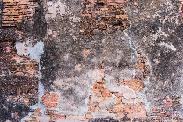 Old broken wall background with bricks.