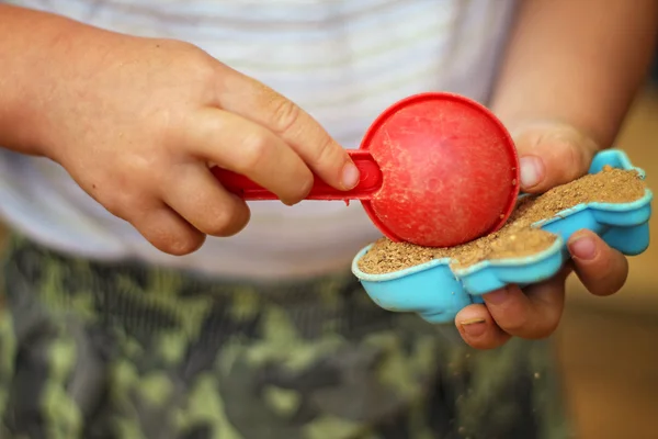 A boy playing in the sandpit — Stock Photo, Image