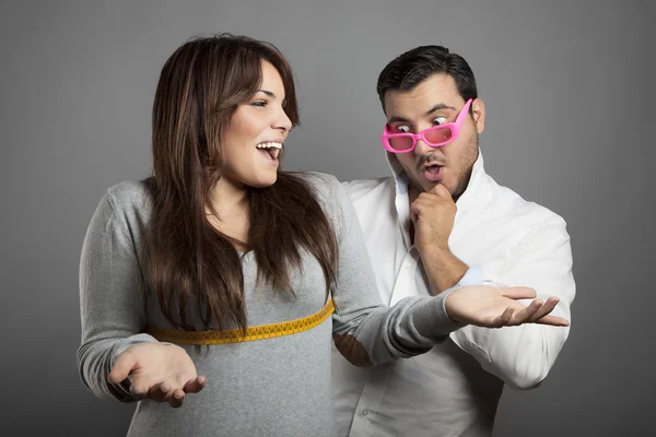 Tailor is surprised looking the woman measures