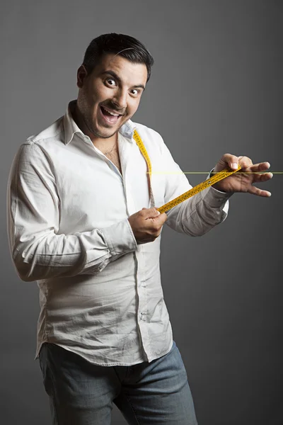 The smiling man showing his sex length — Stock Photo, Image