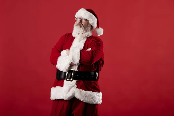 Kerstman Met Gekruiste Armen Een Rode Achtergrond — Stockfoto