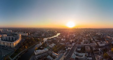 Sunny panorama, aerial view on river Lopan embankment with Skver Strilka park in Kharkiv, Ukraine. Blue clear autumn cityscape, city streets