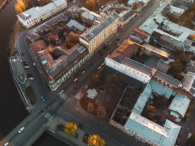 Look down on city streets. Aerial flight above autumn Zalopan district houses on river Lopan embankment, downtown city rooftop in Kharkiv, Ukraine