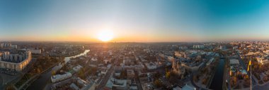 Wide sunny panoramic aerial view above river Lopan embankment near Annunciation Cathedral in Kharkiv, Ukraine. Flag of Ukraine with epic autumn cityscape, city streets