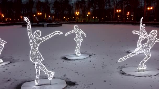 漂亮的冬季装饰 在哈尔科夫市中心结冰的白冰湖上 在格尔基中央公园的夜灯下 滑行着轻盈的花纹 — 图库视频影像