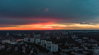 Epic aerial vivid sunset view above residential district. 23 serpnia Pavlovo Pole, Kharkiv city, Ukraine. Majestic evening cloudscape and streets