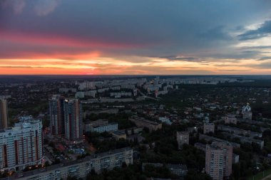 Epic vibrant sunset aerial view in city residential multistory district. Pavlovo Pole, Kharkiv Ukraine. Evening cloudscape and houses