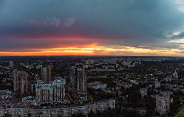 Epic vibrant sunset aerial view in city residential multistory district. 23 serpnia, Pavlovo Pole, Kharkiv, Ukraine. Fly at dusk, evening cloudscape and urban streets
