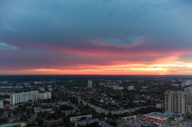 Beautiful colorful sunset above city residential district, aerial view. 23 serpnia, Pavlovo Pole, Kharkiv, Ukraine. Majestic evening cloudscape and streets
