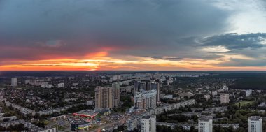 Epic vivid sunset above city residential district, aerial view. 23 serpnia, Pavlovo Pole, Kharkiv, Ukraine. Majestic evening skyscape and city streets