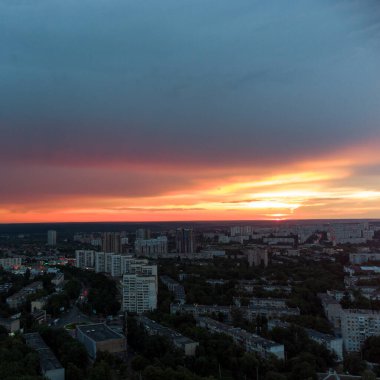 Epic vivid sunset above city residential district, aerial view. Pavlovo Pole, Kharkiv Ukraine. Majestic evening skyscape, cloudscape and houses