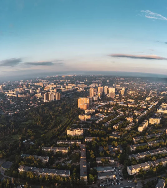 Morning city view in summer green city, residential district near sunny Sarzhyn Yar. Aerial cityscape above buildings and streets, Pavlovo Pole, Kharkiv Ukraine. Vertical