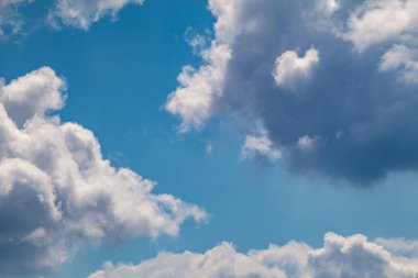 Fluffy white high clouds on bright blue sky, cloudscape background. Skyscape natural heavenly scenery